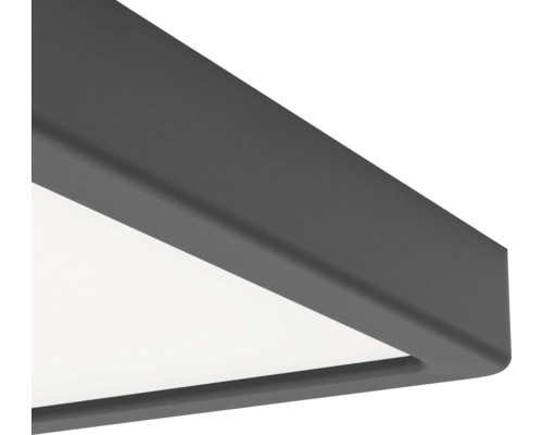 Gros plan sur l'angle d'un plafonnier à panneau LED carré avec un cadre gris foncé mat.