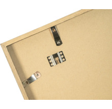 Dos d'un cadre photo en bois avec attaches métalliques et clips de fixation.