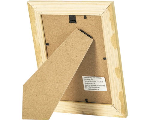 Vue arrière d un cadre photo en bois avec support et clips de fixation en métal.