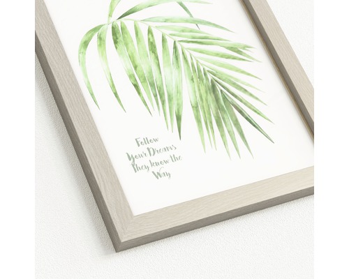 Gerahmtes Bild mit dem Motiv eines Palmenblatts und dem Schriftzug Folge deinen Träumen, sie kennen den Weg