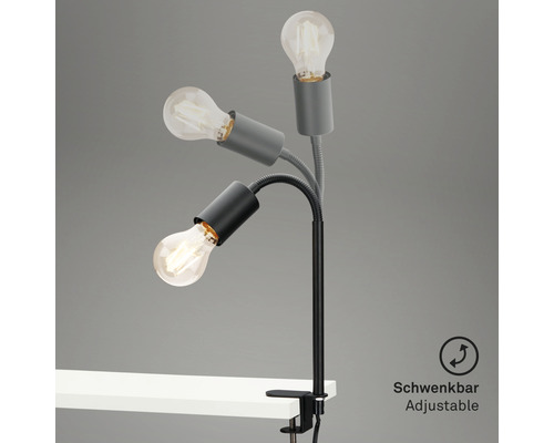 Lampe à pince pivotante avec trois ampoules sur un bureau