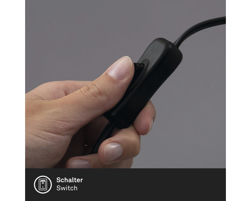 Une main actionne l''interrupteur d''une lampe.