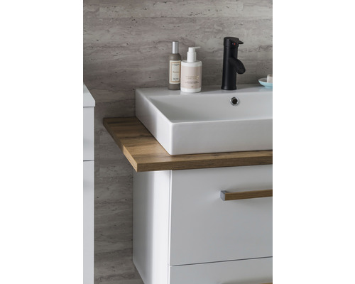 Meuble-lavabo avec meuble bas, vasque à poser, robinetterie et produits de soin dans la salle de bain