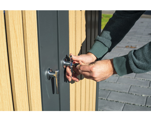 Une personne ouvre une porte avec une serrure et une clé