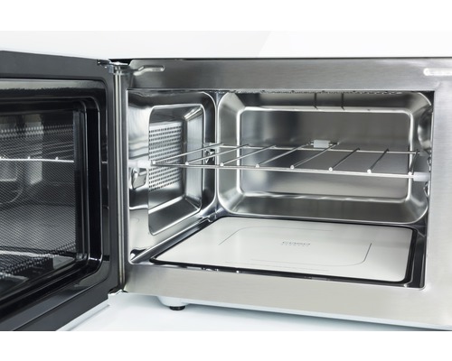 Intérieur d''un four à micro-ondes ouvert avec grille et fond en céramique