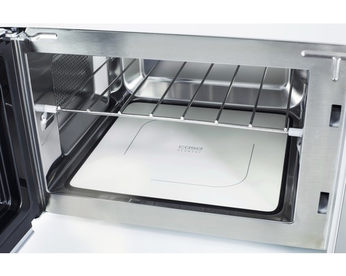 Intérieur d''un four à micro-ondes en acier inoxydable avec grille et plaque de verre