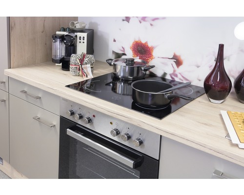 Scène de cuisine avec cuisinière, plaques de cuisson, casseroles et ustensiles de cuisine sur un plan de travail clair