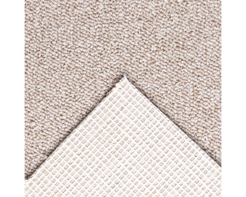 Detailansicht eines beigefarbenen Teppichs mit rutschfester Rückseite.