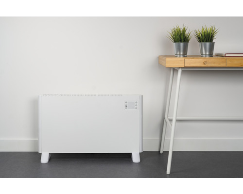 Radiateur électrique blanc à côté d''un bureau avec des plantes en pot