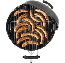 Barbecue rond avec grille et saucisses grillées dessus.