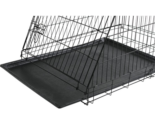 Vue détaillée d''une cage pour chien avec grille métallique et bac en plastique