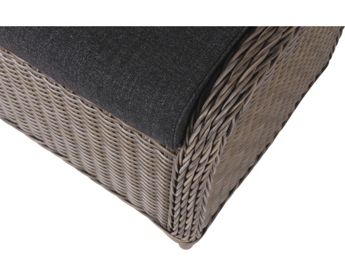 Gros plan d''un fauteuil en osier avec coussin gris.