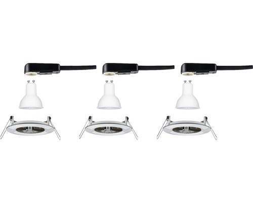 Trois luminaires apparents démontés avec spots sur rail noirs et cadres encastrés ronds