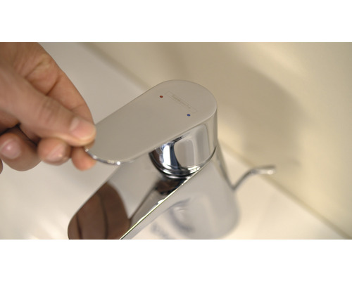 Hand betätigt Armatur für Waschbecken im Badezimmer