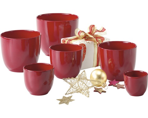 Groupe de cache-pots rouges avec cadeau et décorations de Noël