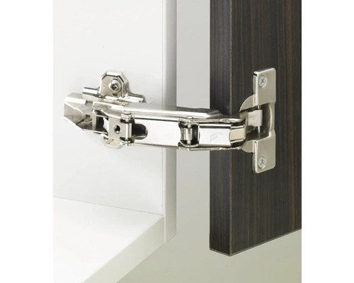 Charnière métallique fixée à une porte d''armoire