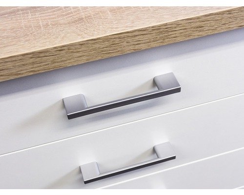 Gros plan sur deux tiroirs avec poignées et un plan de travail.
