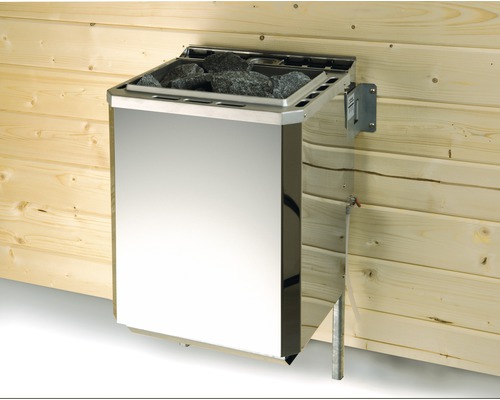 Poêle de sauna en métal avec pierres sur mur en bois