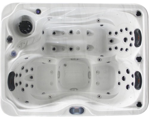 Photo d''un jacuzzi vu de dessus avec plusieurs sièges et jets.