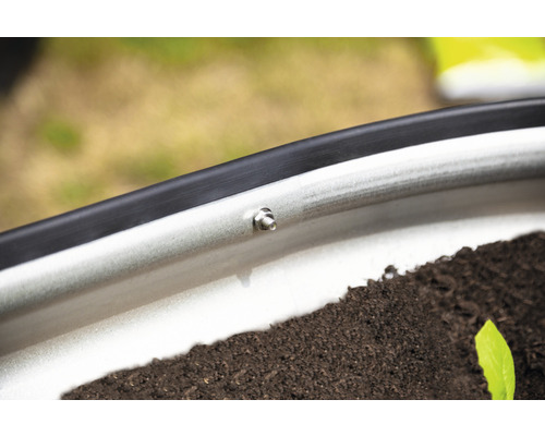 Gros plan d''un parterre de culture surélevé avec vis et terre