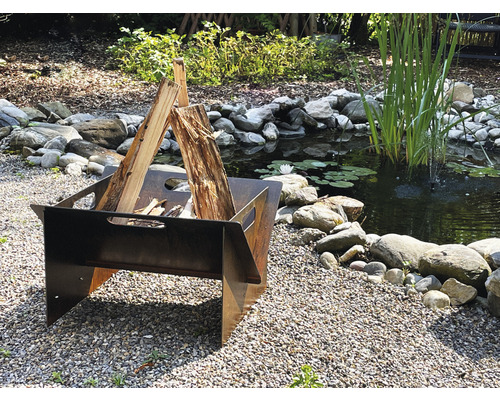 Feuerstelle im Garten mit Teich und Steinen.