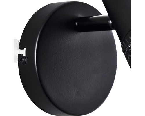 Detailaufnahme einer schwarzen Wandleuchte mit runder Wandhalterung