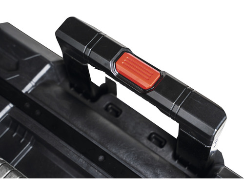 Vue détaillée de la poignée d''une boîte à outils avec un bouton rouge