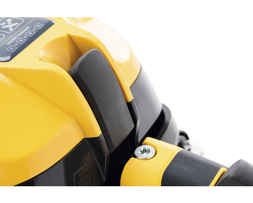 Gros plan d''un appareil jaune avec levier noir et mode d''emploi.