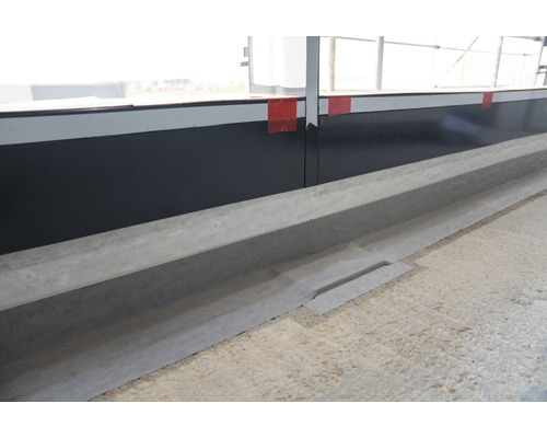 Vue détaillée d''une rigole de drainage dans le sol.