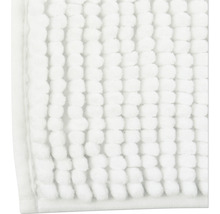Gros plan d''un tapis de bain blanc avec structure à picots