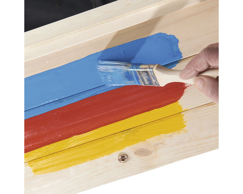 Peindre du bois avec un pinceau et différentes couleurs