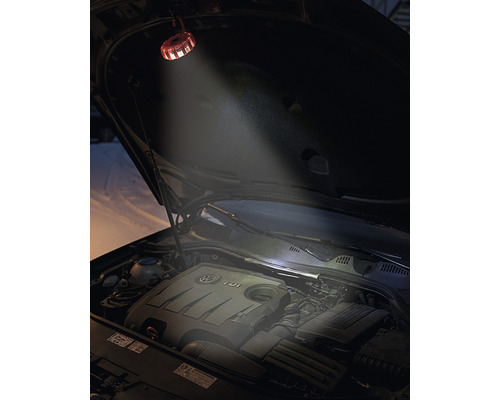 Une lampe de compartiment moteur éclaire le compartiment moteur ouvert d''une voiture.