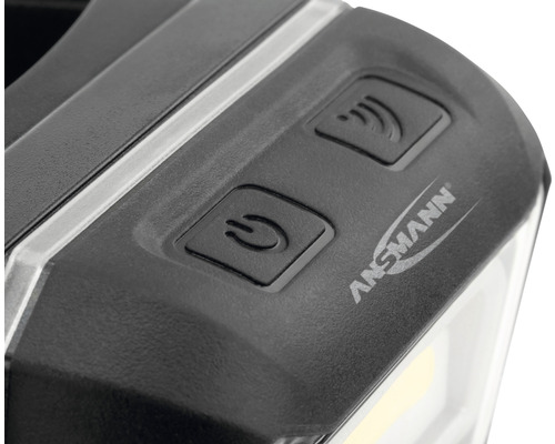 Vue détaillée d''une lampe avec le logo Ansmann, un interrupteur marche/arrêt et un symbole de signal sans fil.