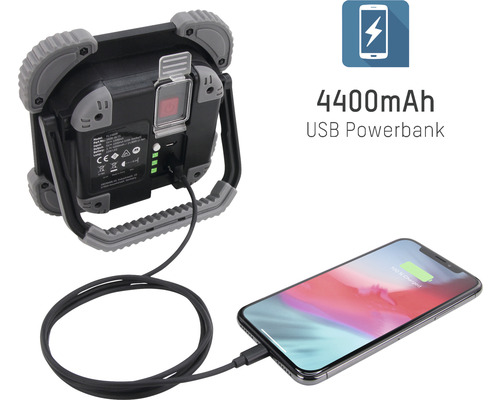 Projecteur de chantier à LED avec batterie de secours USB et câble de charge chargeant un téléphone mobile