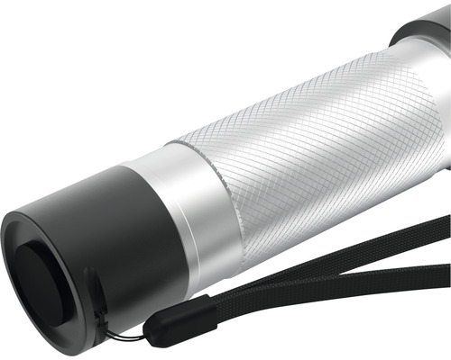 Gros plan d''une lampe de poche argentée avec dragonne