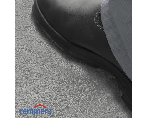 Nahaufnahme eines Arbeitsschuhs auf einer Betonoberfläche, Remmers Logo