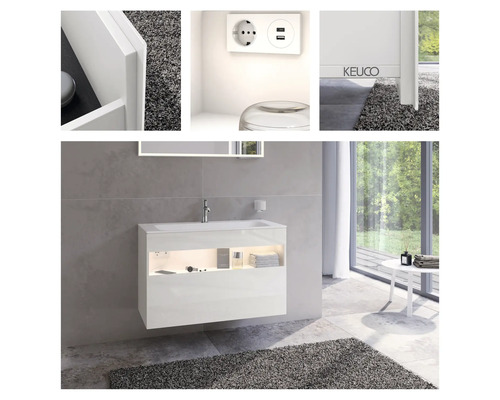 Salle de bains moderne avec meuble sous-lavabo blanc, miroir et éclairage intégré, ainsi qu''une prise avec ports USB.