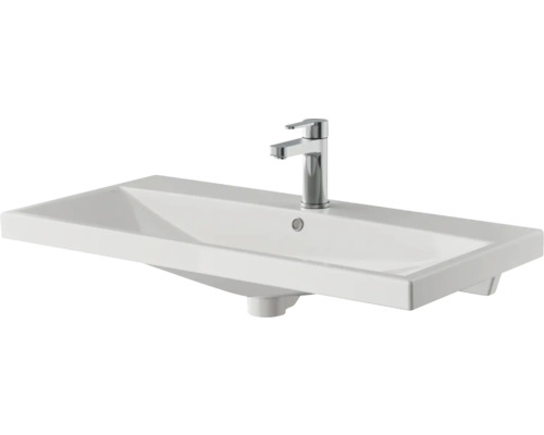 Lavabo en céramique avec robinetterie pour la salle de bains