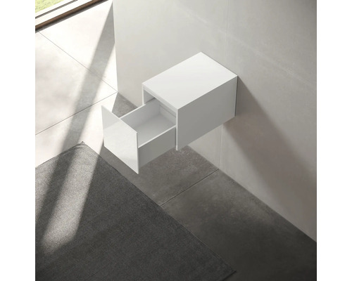 Meuble-lavabo suspendu blanc avec tiroir ouvert dans salle de bains