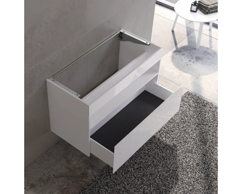 Meuble sous-lavabo mural avec tiroir ouvert dans une salle de bains