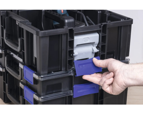 Caisses à outils empilées avec outil et main.