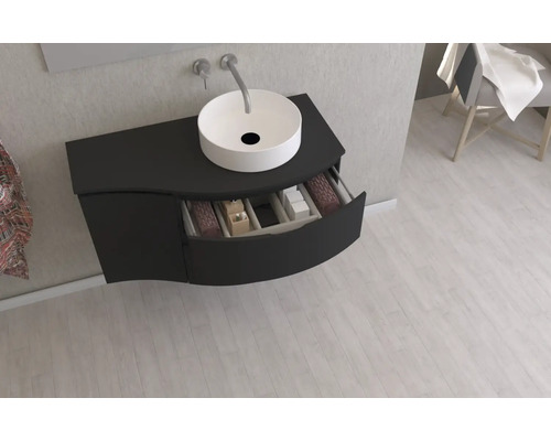 Meuble-lavabo avec tiroir ouvert et lavabo à poser dans la salle de bains