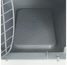Vue intérieure d''une cage de transport pour animaux de compagnie avec porte grillagée et fond perforé