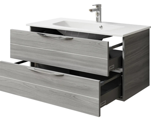 Meuble sous-lavabo avec deux tiroirs ouverts, lavabo et robinet