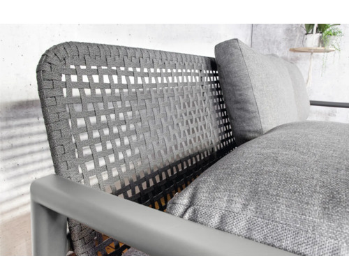 Detailansicht eines Outdoor-Sessels mit Rattangeflecht und Kissen