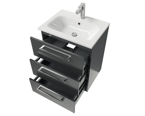 Meuble sous-lavabo avec trois tiroirs ouverts et robinet