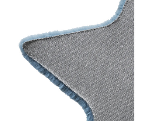Vue détaillée d''un tapis en forme d''étoile avec un dessous en textile et des franges