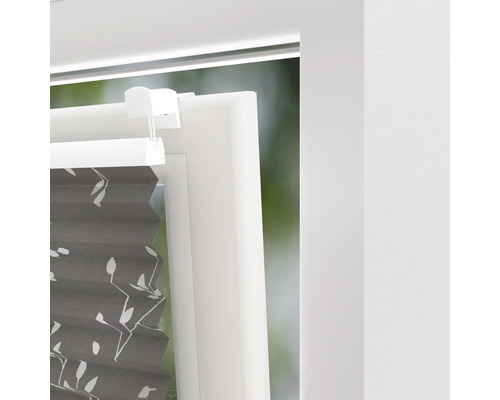 Vue détaillée d''un store plissé gris avec motif floral sur la fenêtre