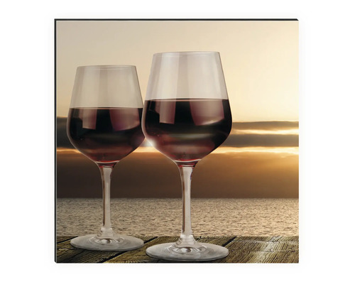 Tableau mural avec deux verres à vin devant un coucher de soleil