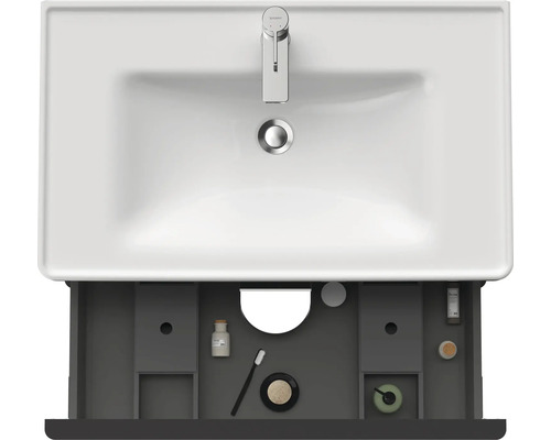 Vue de dessus d''un meuble sous-lavabo avec tiroir ouvert et divers accessoires de salle de bains